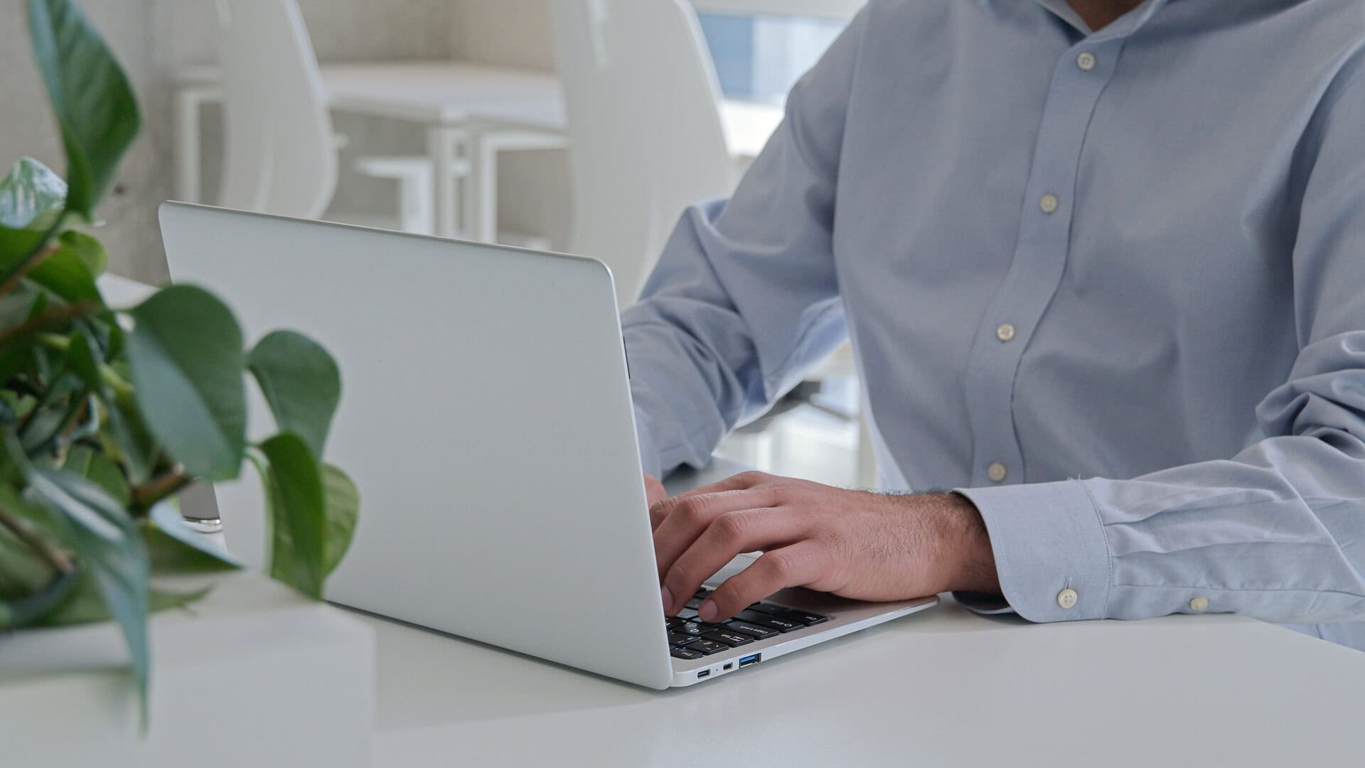 Professional working on a laptop in a calm office environment with managed email security support
